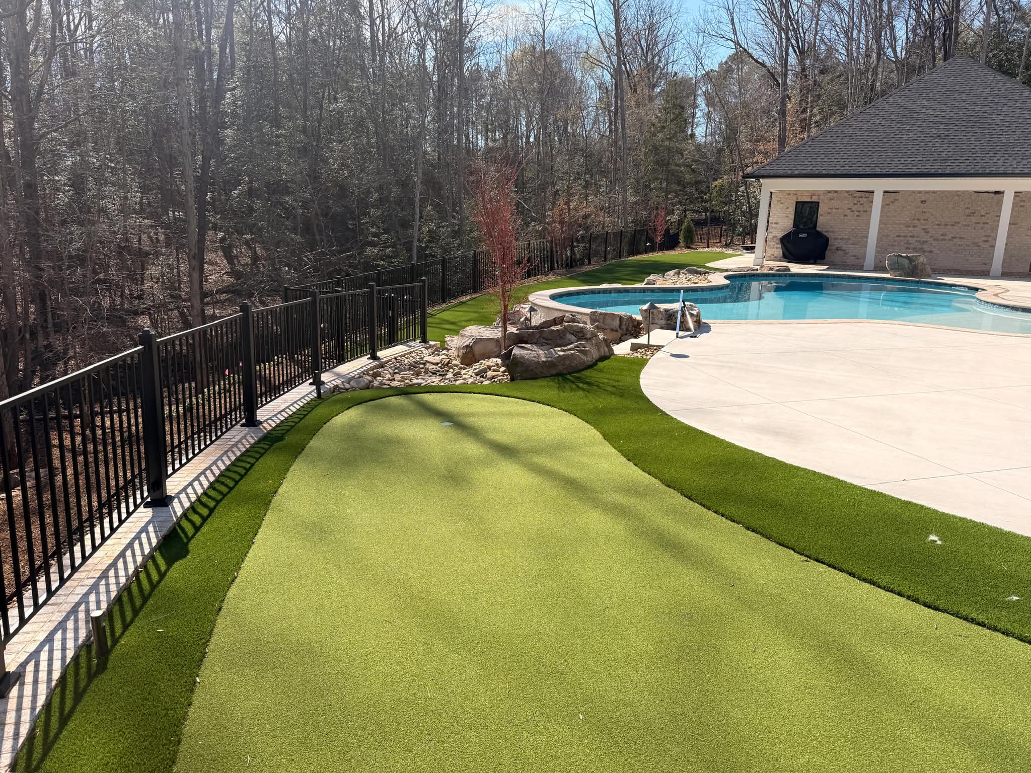 Synthetic turf golf green with a clean layout and natural shape, installed for a homeowner near Fort Mill, SC.