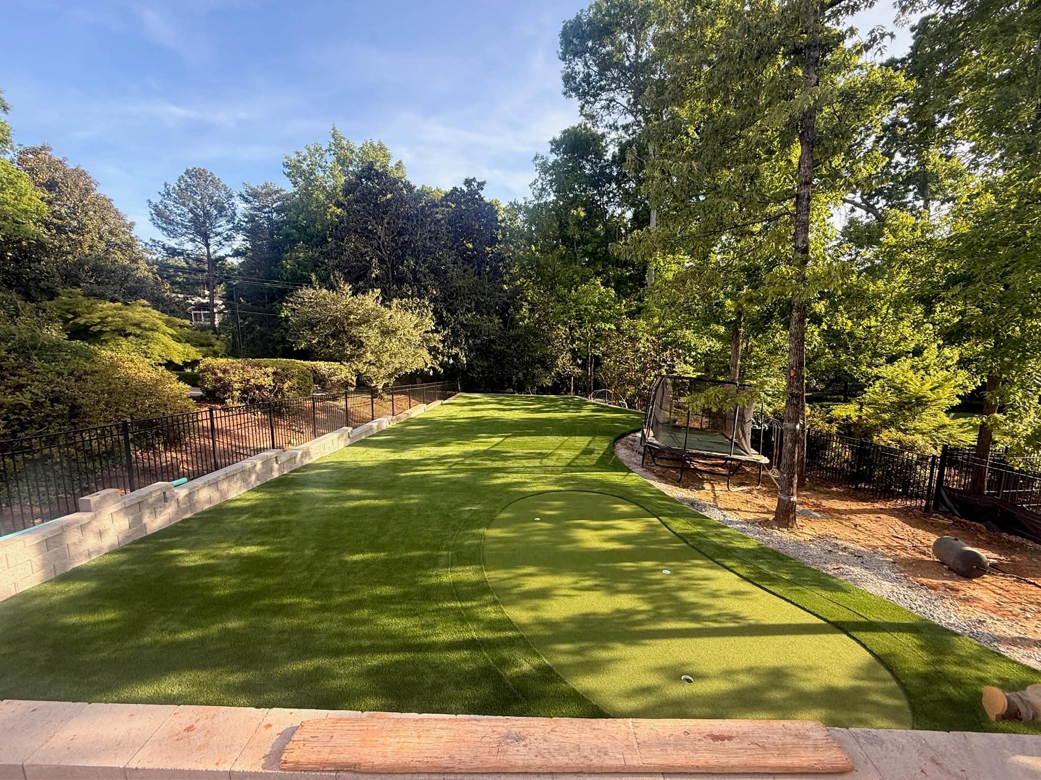 Backyard golf practice area with artificial turf, giving Fort Mill homeowners a dedicated space for putting and chipping.