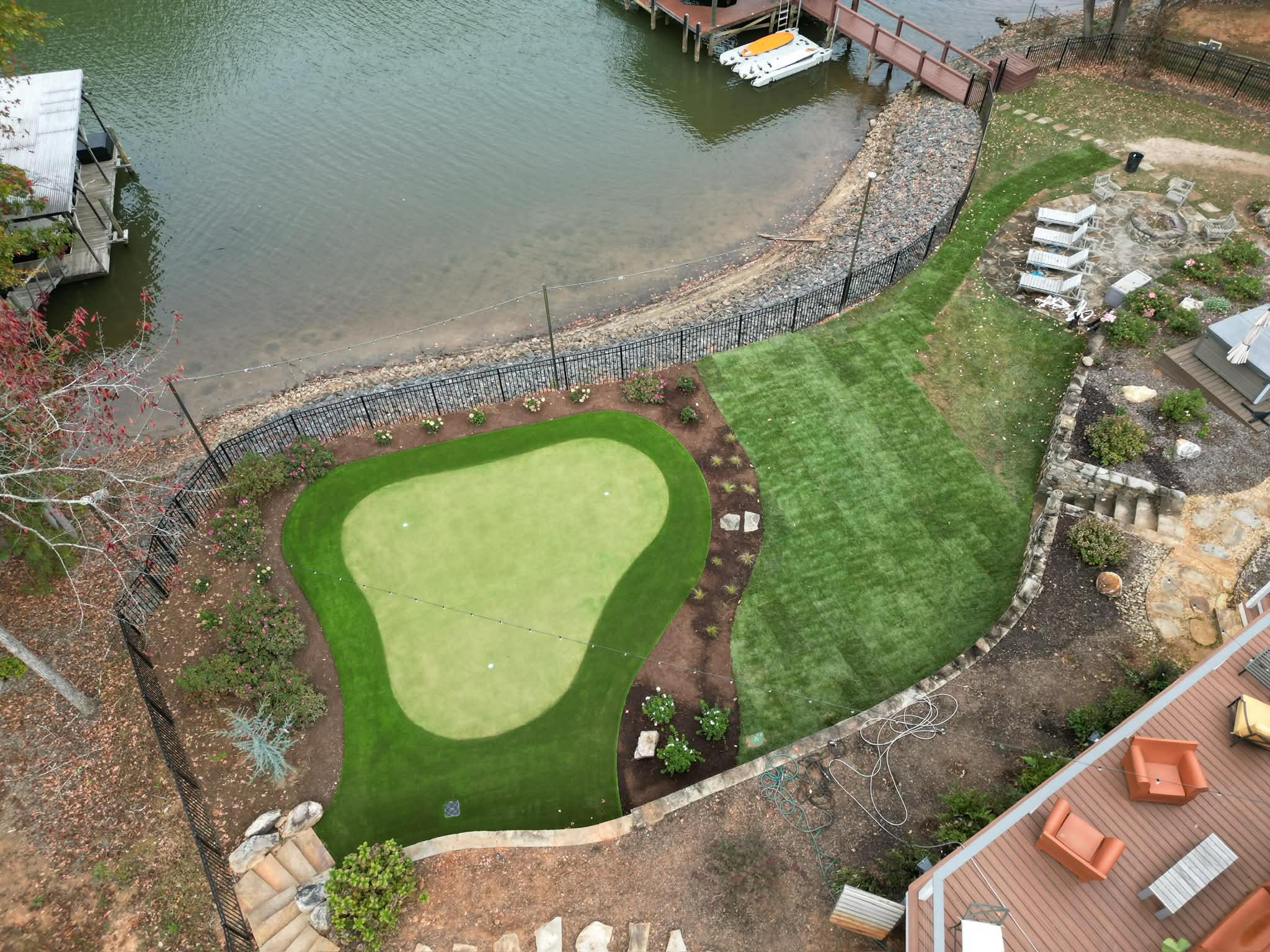 Backyard golf green with synthetic turf, designed to fit naturally into an outdoor living space in the Fort Mill area.